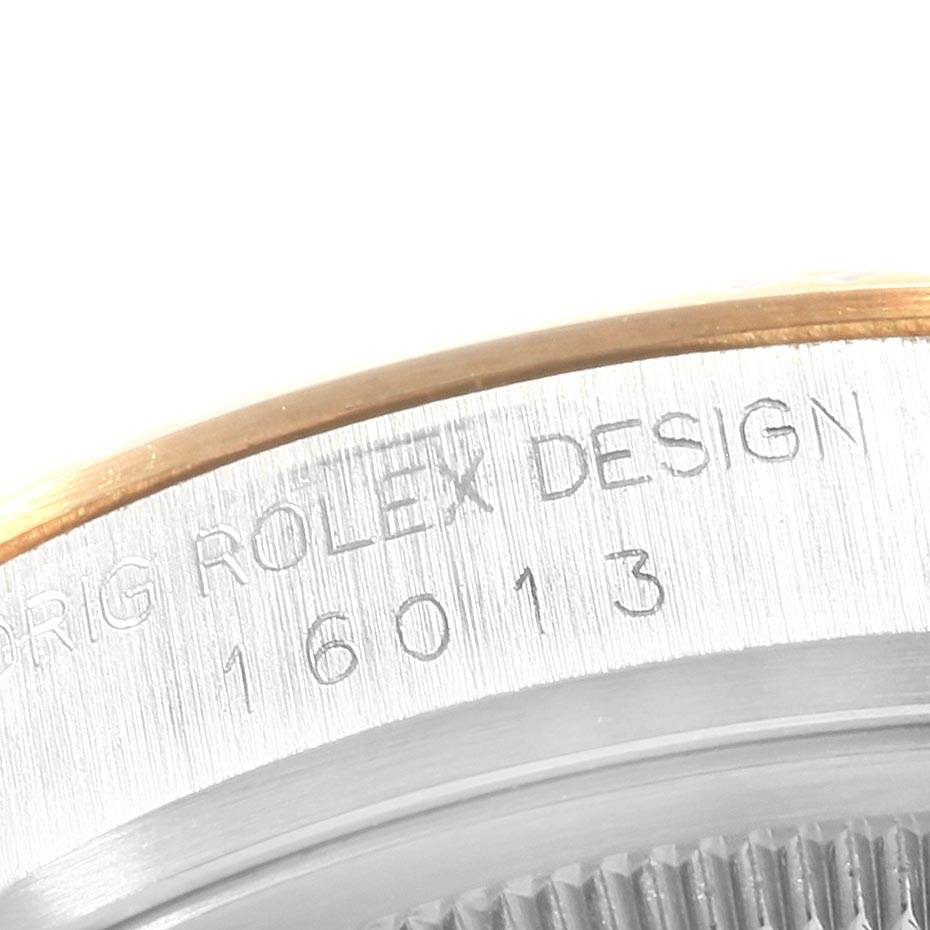 This close-up image shows the case back engraving and part of the bezel of a Vintage Collection Rolex watch, model 16013.