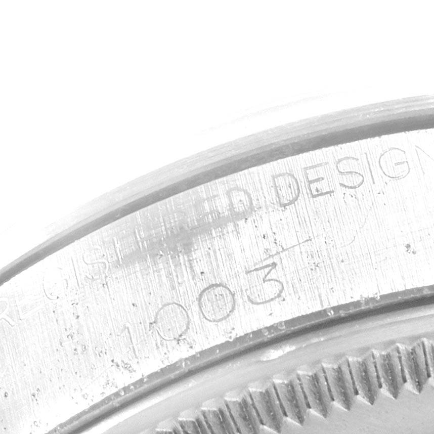The image shows a close-up of the edge and engraved markings on the back of a Vintage Collection model by Rolex.