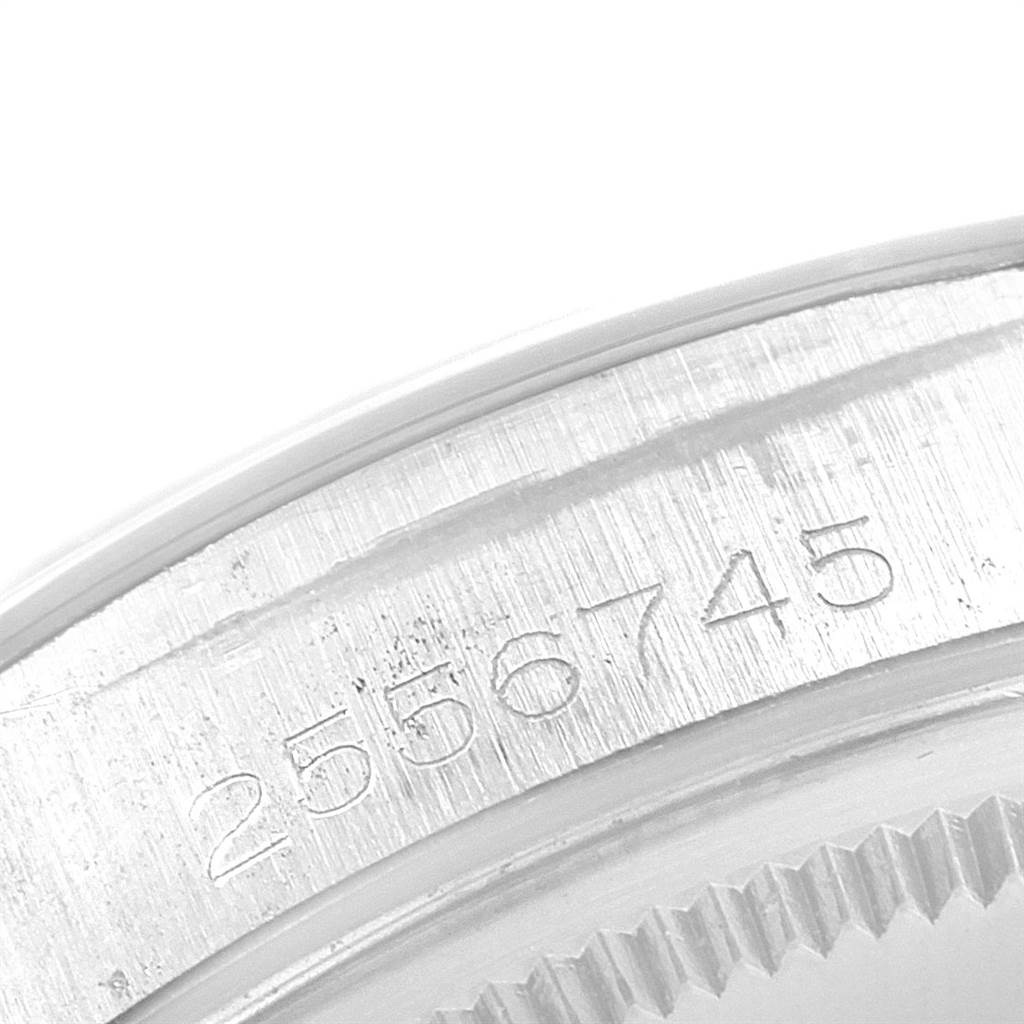 The image shows a close-up of the serial number engraved on the case of a Vintage Collection model by Rolex.