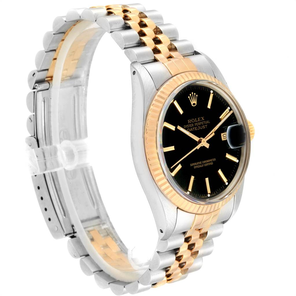 This image shows a side angle of a Rolex Vintage Collection 16013 Men's Stainless Steel Black Dial 16013 Men's Stainless Steel Black Dial watch, highlighting its gold and silver bracelet, black dial, and fluted bezel.