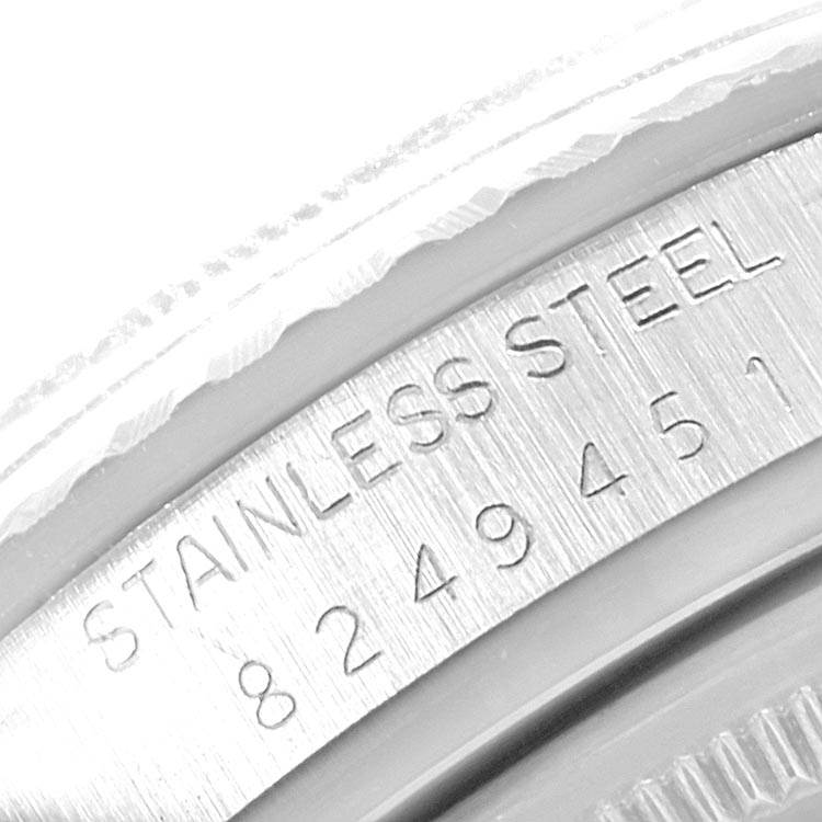 This close-up image shows the etched serial number and "STAINLESS STEEL" marking on the case of a Rolex Vintage Collection 16030 Men's Stainless Steel Silver Dial 16030 Men's Stainless Steel Silver Dial watch.