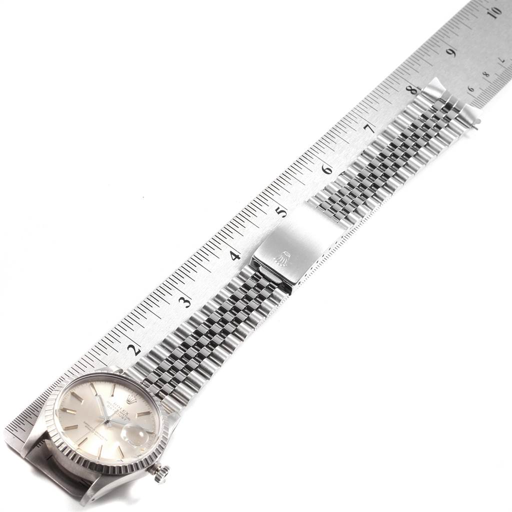 The image shows a Rolex Vintage Collection 16030 Men's Stainless Steel Silver Dial 16030 Men's Stainless Steel Silver Dial model laid flat with its bracelet band and face alongside a metal ruler for measurement.