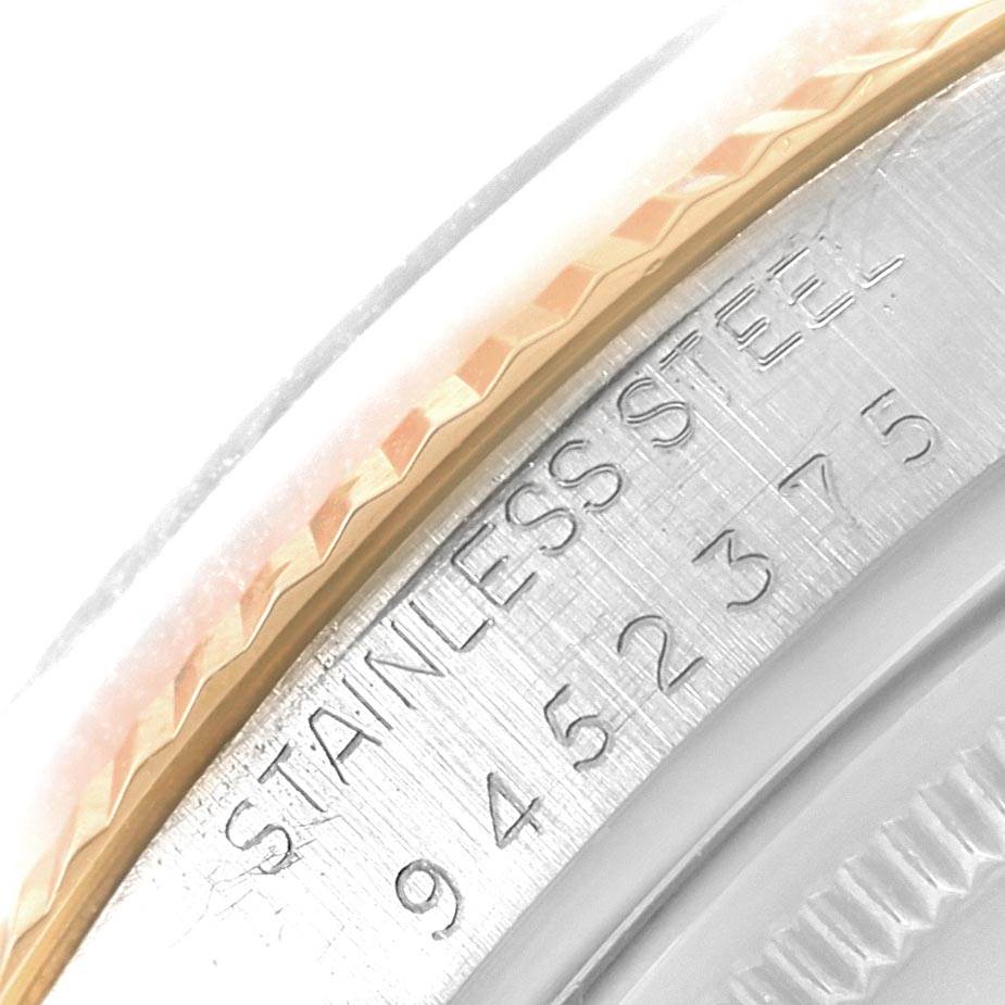 The image shows a close-up of the engraved stainless steel case and bezel of the Rolex Vintage Collection 16013 Men's Stainless Steel Champagne Dial 16013 Men's Stainless Steel Champagne Dial watch.