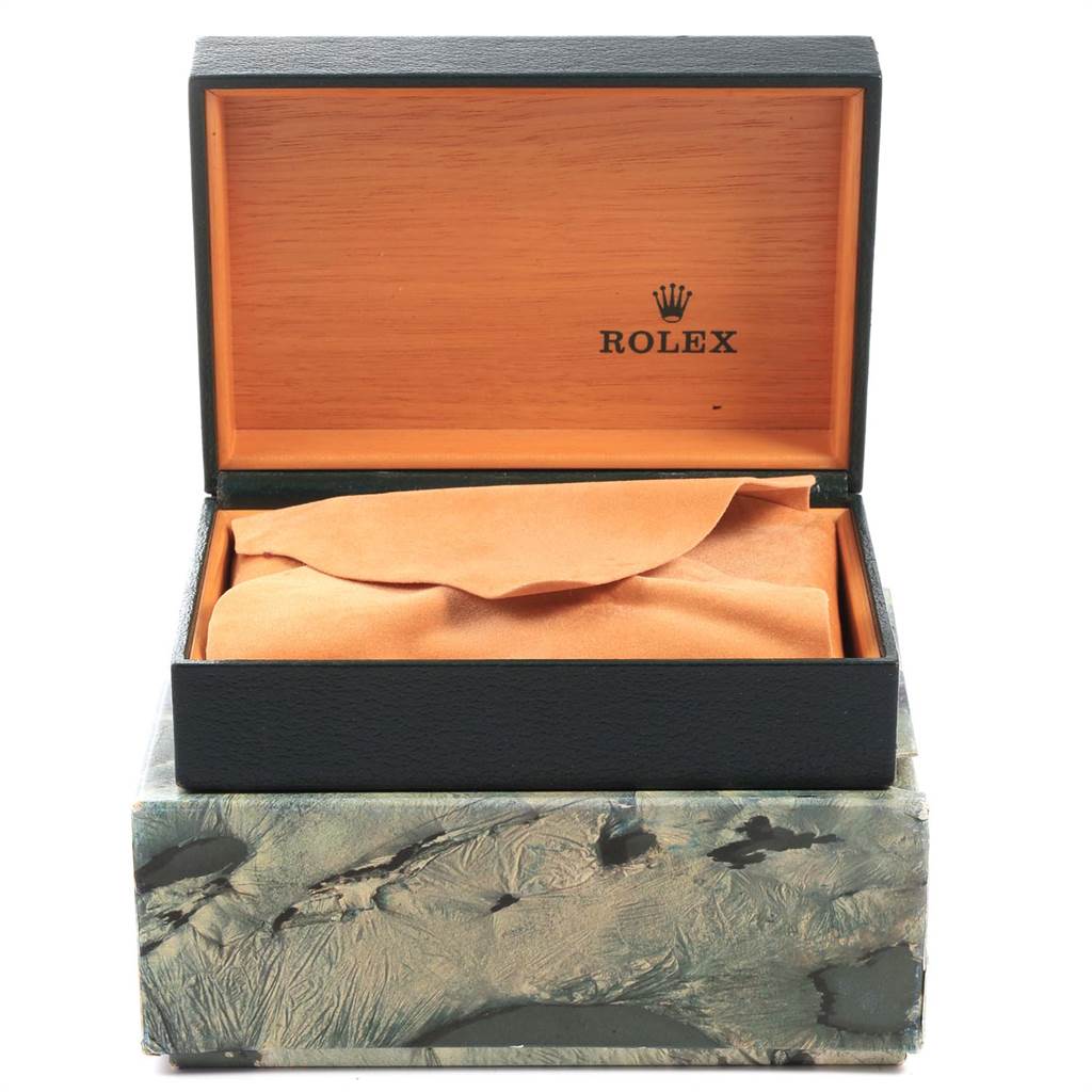The image shows an open box containing a Vintage Collection model by Rolex, with the watch partially covered by a cloth.