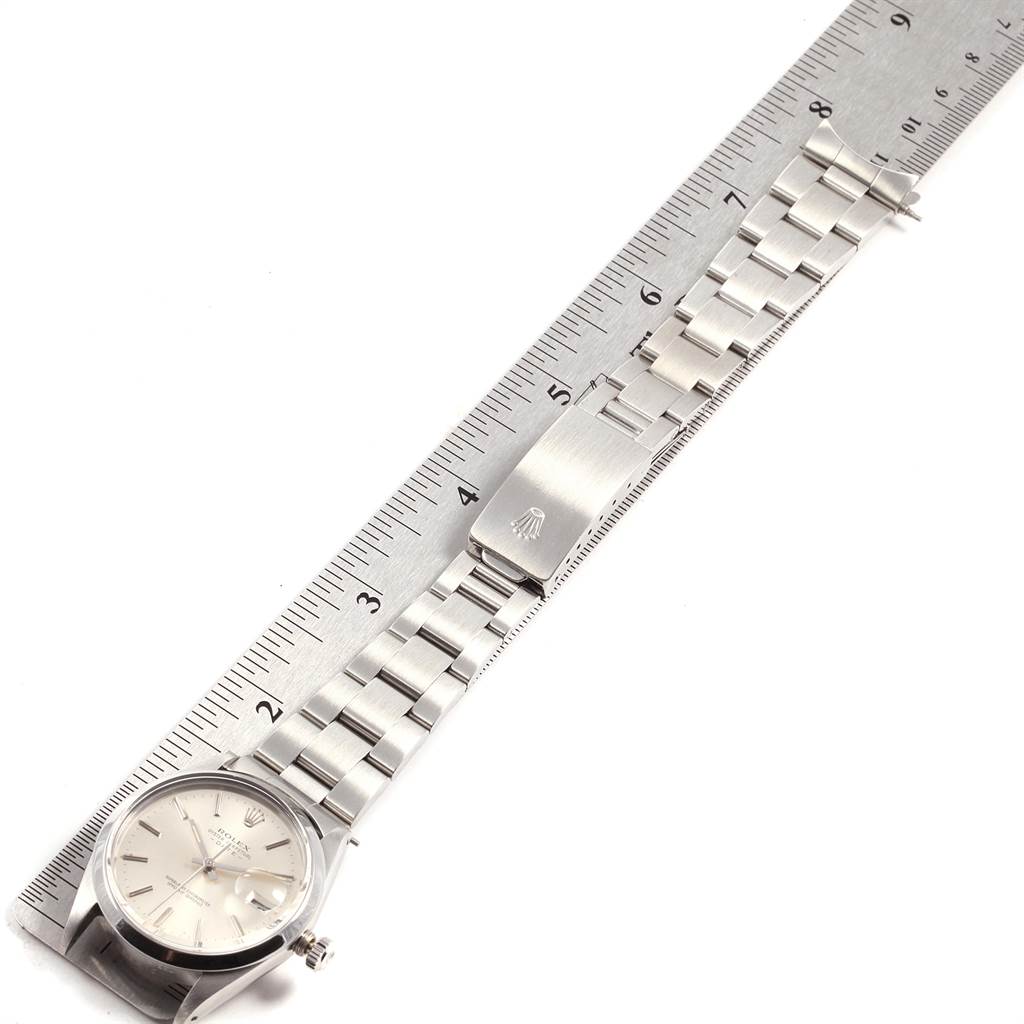 The image shows a horizontal view of a Rolex Vintage Collection 15000 Men's Stainless Steel Silver Dial 15000 Men's Stainless Steel Silver Dial watch with its face, bracelet, and clasp measured against a ruler.