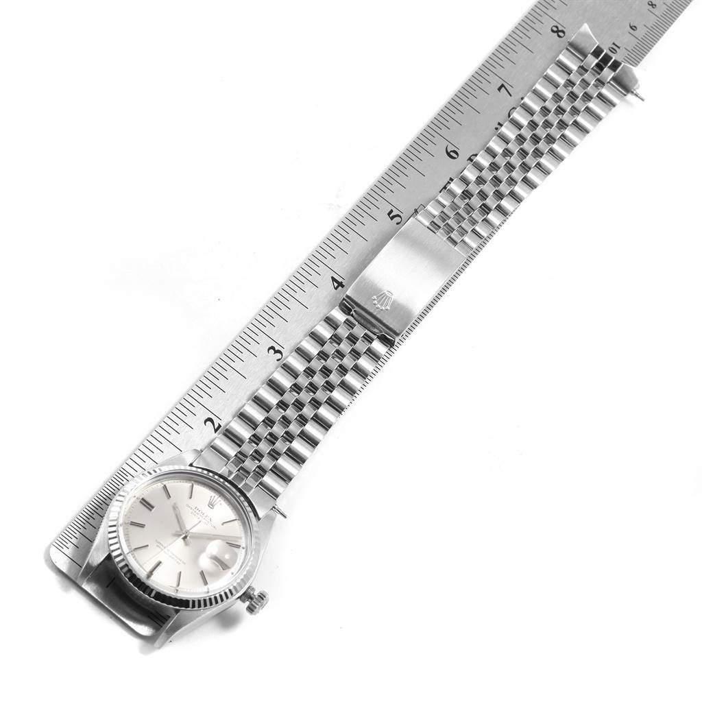 The Rolex Vintage Collection 1601 Men's Stainless Steel Silver Dial 1601 Men's Stainless Steel Silver Dial watch is shown from a top angle, displaying the face, bezel, and bracelet aligned with a ruler.