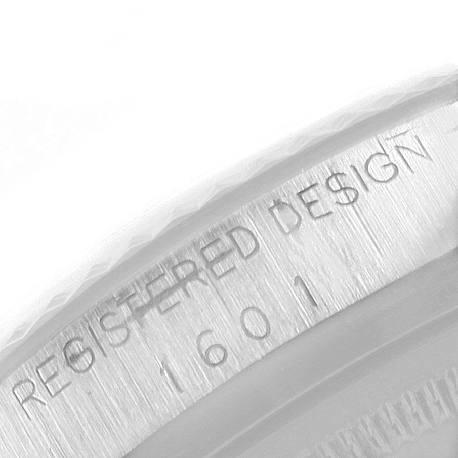 The image shows a close-up of the case back engraving on a Rolex Vintage Collection 1601 Men's Stainless Steel Silver Dial 1601 Men's Stainless Steel Silver Dial model 1601, highlighting the "REGISTERED DESIGN" text.
