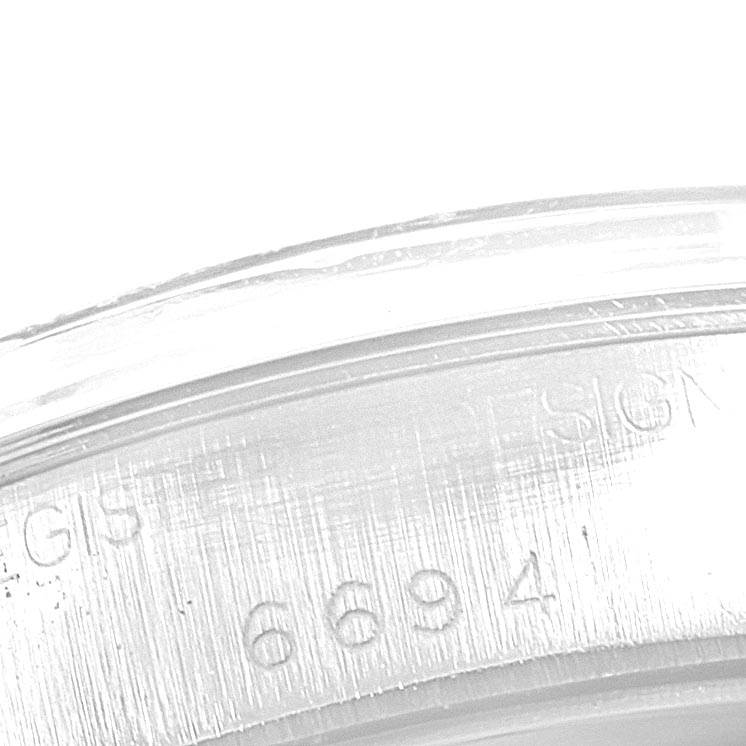 This image shows a close-up view of the serial or model number "6694" engraved on the side of a Vintage Collection Rolex watch.