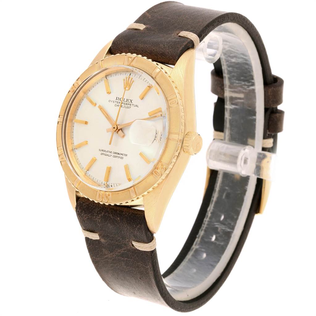 The image shows a Rolex Vintage Collection 1625 Men
s Yellow Gold Silver Dial 1625 Men
s Yellow Gold Silver Dial watch at a three-quarter angle, displaying the face, bezel, crown, and leather strap.