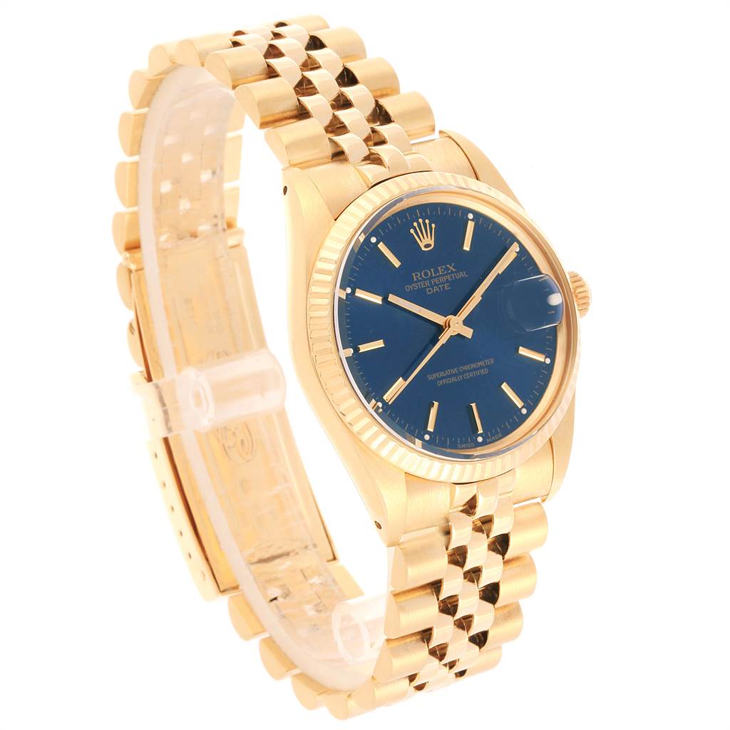 The Vintage Collection Rolex watch is shown at a slight side angle, displaying its blue dial, gold case, and bracelet.