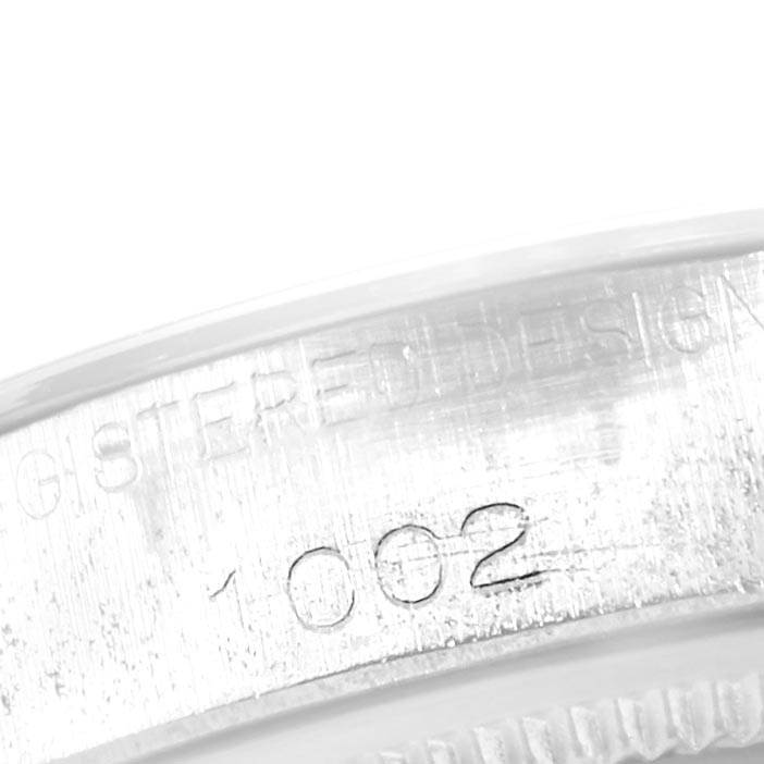 The image shows a close-up of the serial number engraving on the casing of a Vintage Collection model Rolex watch.