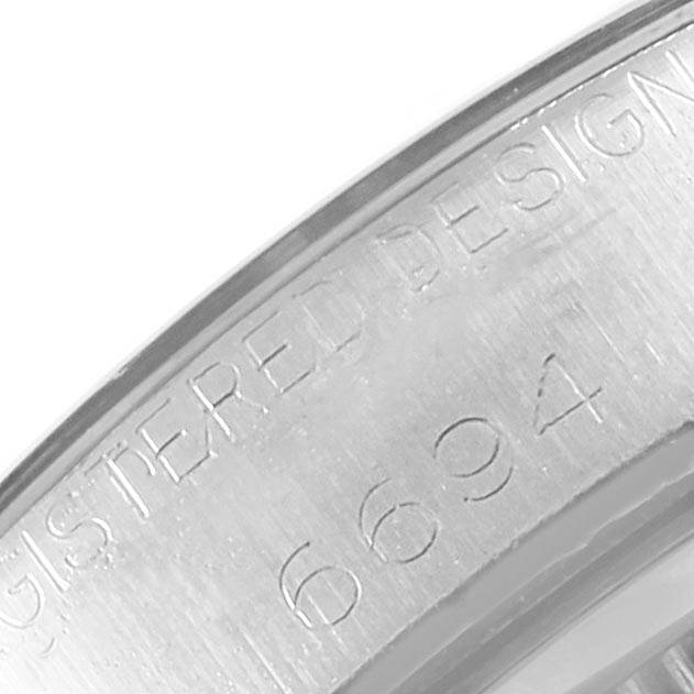 The image shows a close-up angle of the engraved bezel or inner case of the Rolex Vintage Collection 6694 Men's Stainless Steel Silver Dial 6694 Men's Stainless Steel Silver Dial model, including its serial number.