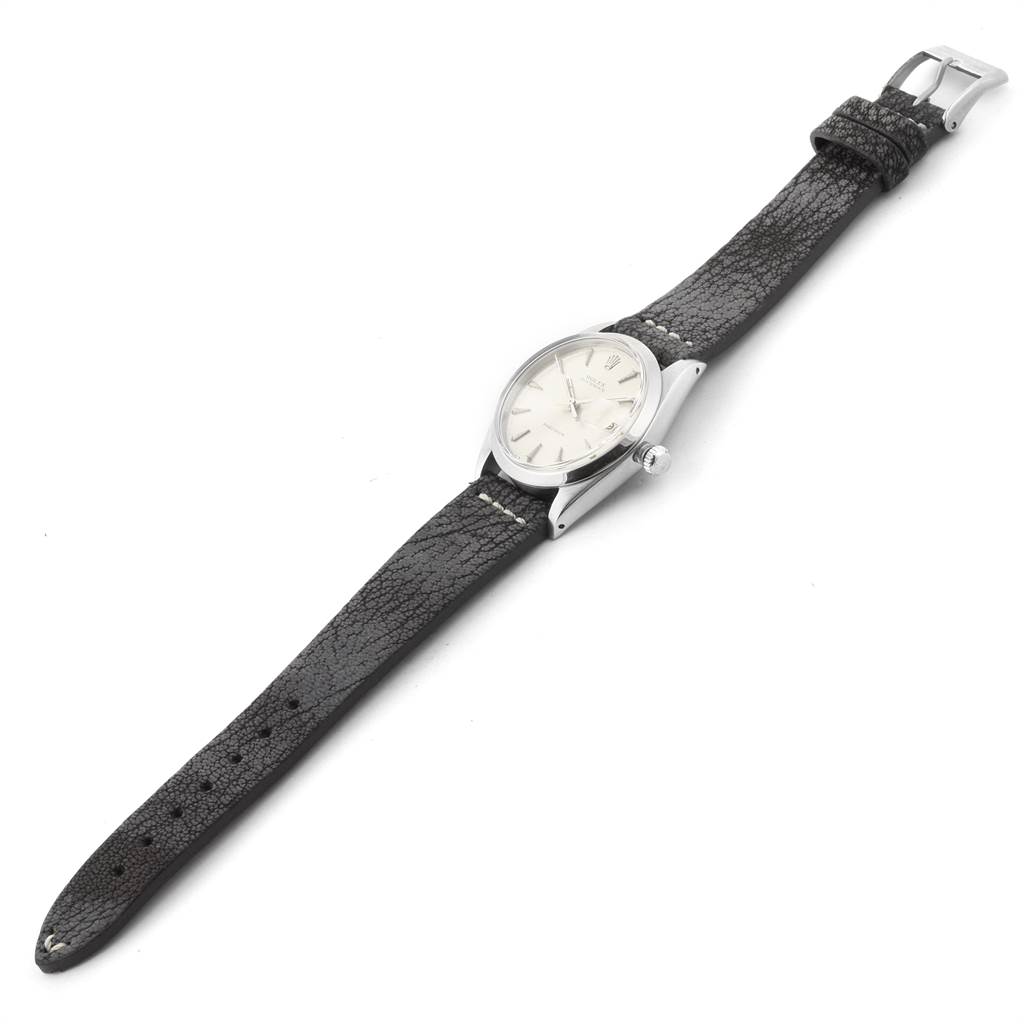 The image shows a Vintage Collection Rolex watch laid flat, showcasing its dial, case, crown, and leather strap.