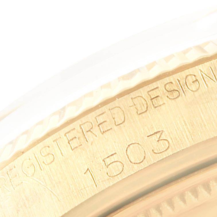 This close-up image shows the Registered Design marking and model number (1503) on the edge of a Rolex Vintage Collection 1503 Men's Yellow Gold Brown Dial 1503 Men's Yellow Gold Brown Dial watch case.