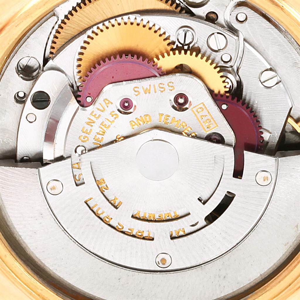 This image shows the intricate internal mechanisms of a Rolex Vintage Collection 1503 Men's Yellow Gold Brown Dial 1503 Men's Yellow Gold Brown Dial watch, including gears and engravings.