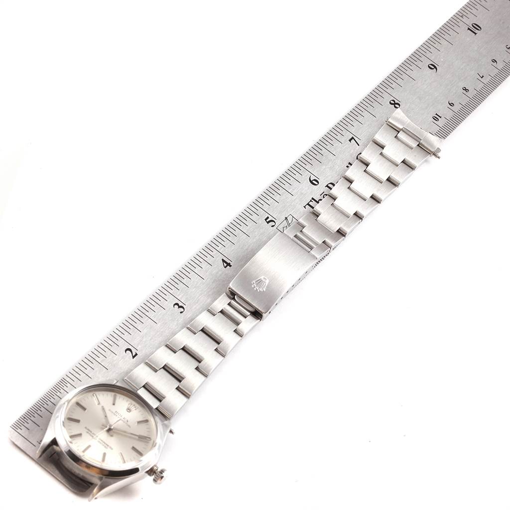 The Rolex Vintage Collection 1002 Men's Stainless Steel Silver Dial 1002 Men's Stainless Steel Silver Dial watch is shown laying flat with the dial, bracelet, and clasp in view, alongside a ruler for measurement.