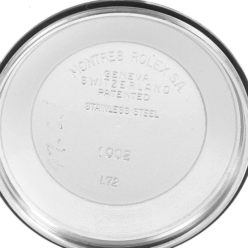 This image shows the inside of the case back of a Rolex Vintage Collection 1002 Men's Stainless Steel Silver Dial 1002 Men's Stainless Steel Silver Dial watch labeled with model details and material.