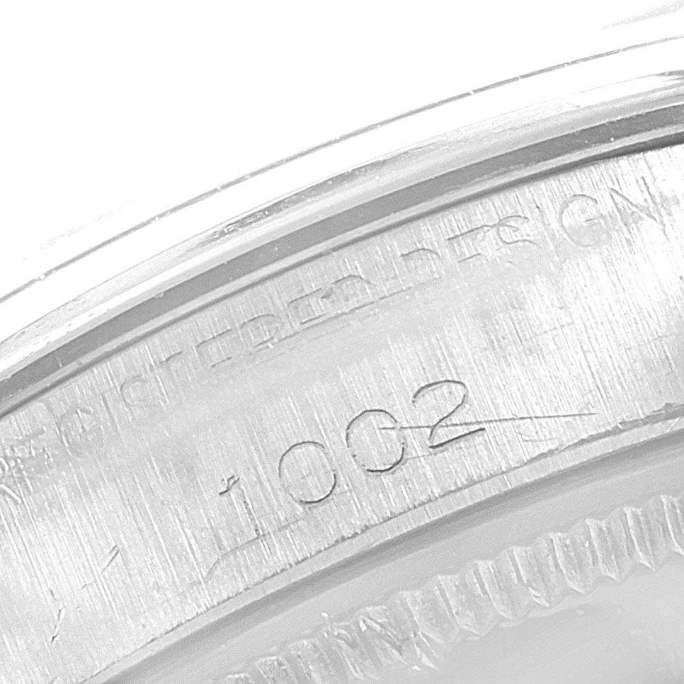 The image shows a close-up of the engravings on the case back of a Rolex Vintage Collection 1002 Men's Stainless Steel Silver Dial 1002 Men's Stainless Steel Silver Dial watch.