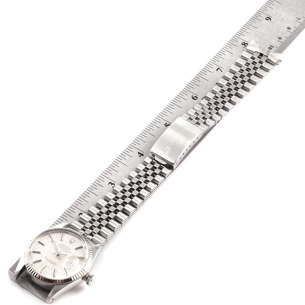 The image shows a Rolex Vintage Collection 16014 Men's Stainless Steel Silver Dial 16014 Men's Stainless Steel Silver Dial watch laid flat next to a ruler, displaying its face, bracelet, and clasp.