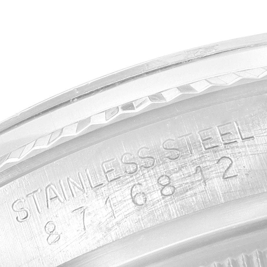 This image shows the serial number and "STAINLESS STEEL" inscription on the casing of a Rolex Vintage Collection 16014 Men's Stainless Steel Silver Dial 16014 Men's Stainless Steel Silver Dial model watch.