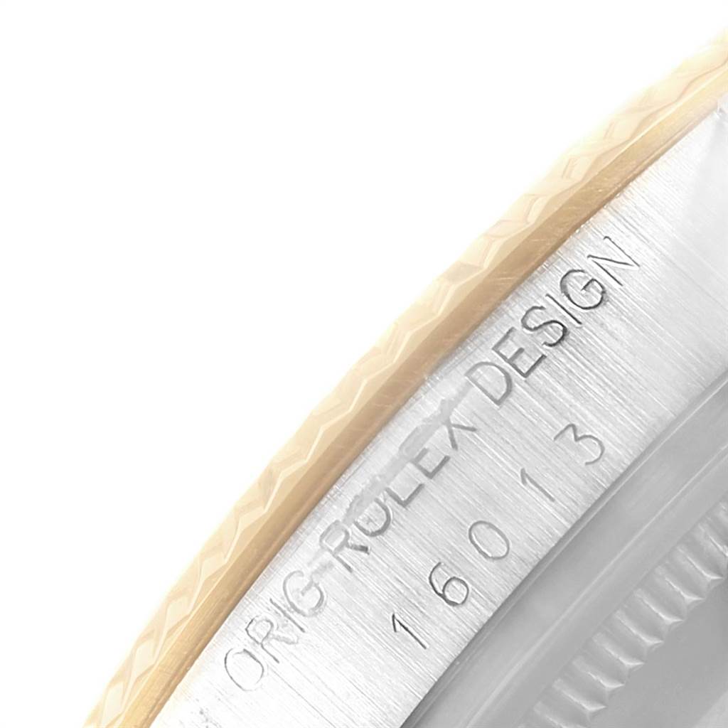 The image shows a close-up of the edge of the bezel and the engraved serial number on the case of a Rolex Vintage Collection 16013 Men's Stainless Steel Champagne Dial 16013 Men's Stainless Steel Champagne Dial model watch.