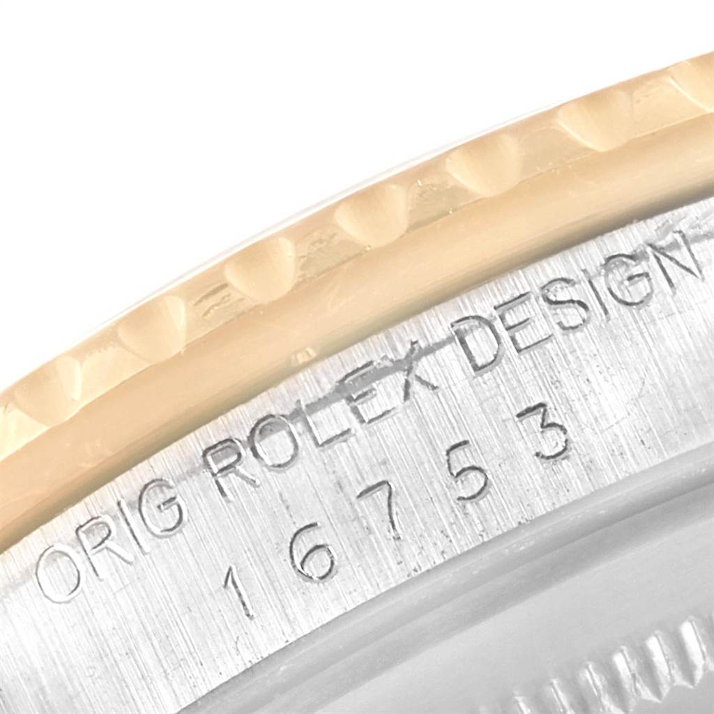 Close-up of a bezel and engraving on the Vintage Collection model by Rolex, showing part of the serial number and design mark.