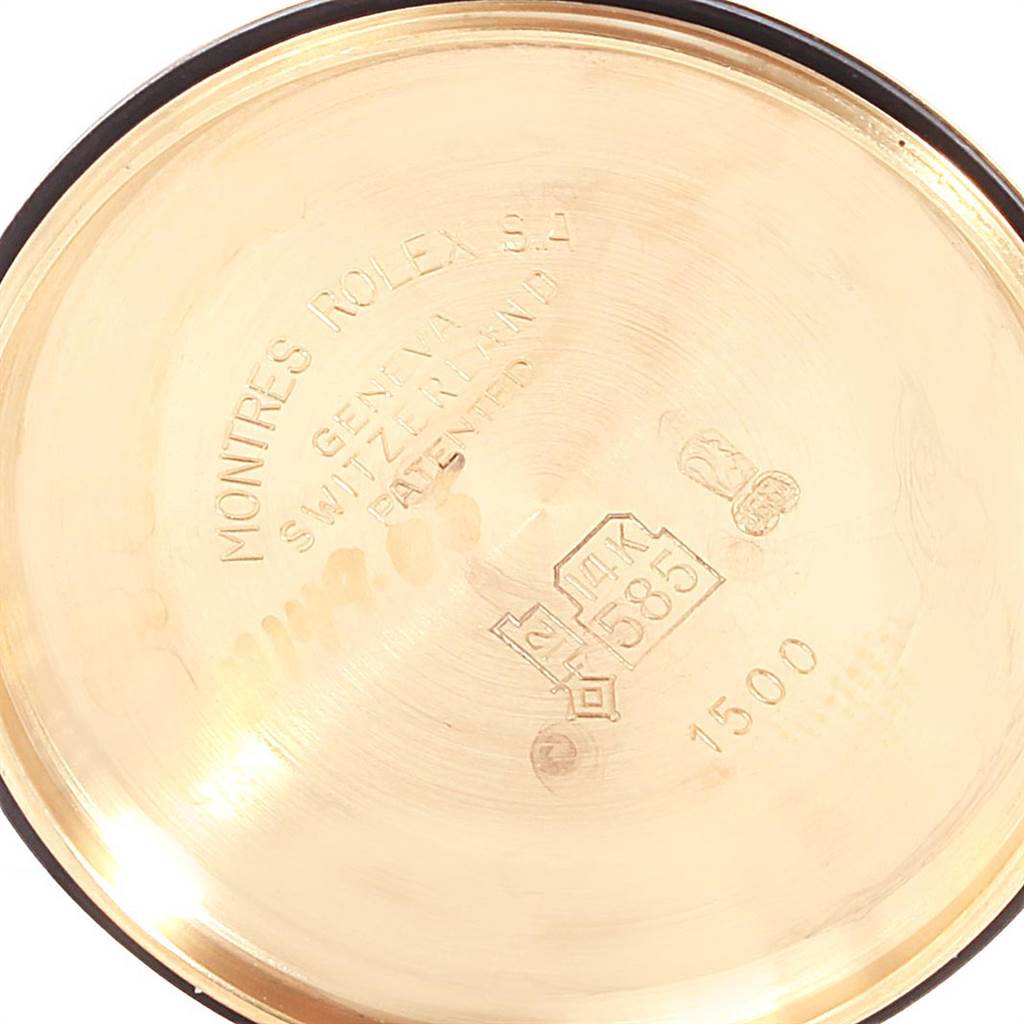 This image shows the inside case back of a Vintage Collection Rolex watch, featuring engravings and a hallmark.