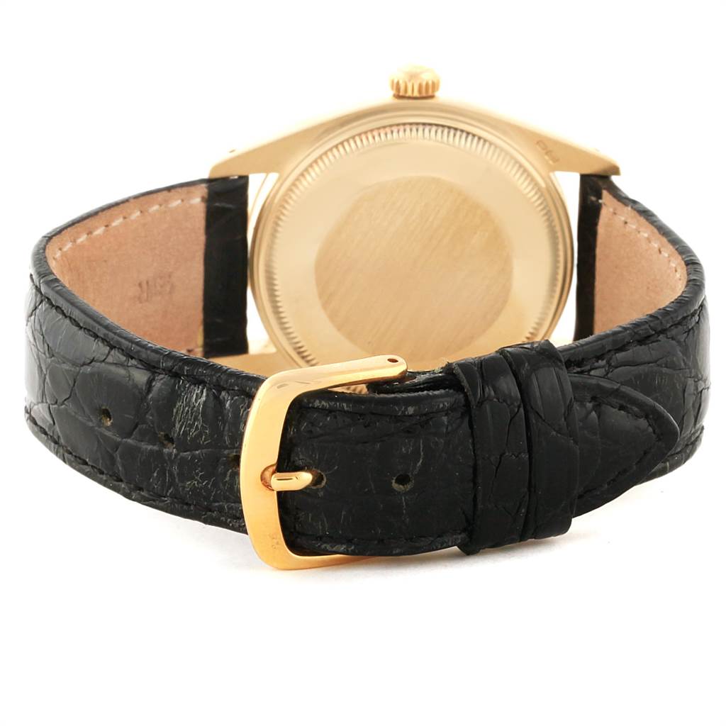 The Rolex Vintage Collection 1503 Men
s Yellow Gold Champagne Dial 1503 Men
s Yellow Gold Champagne Dial watch is shown from the back, highlighting its gold case and black leather strap with a gold buckle.