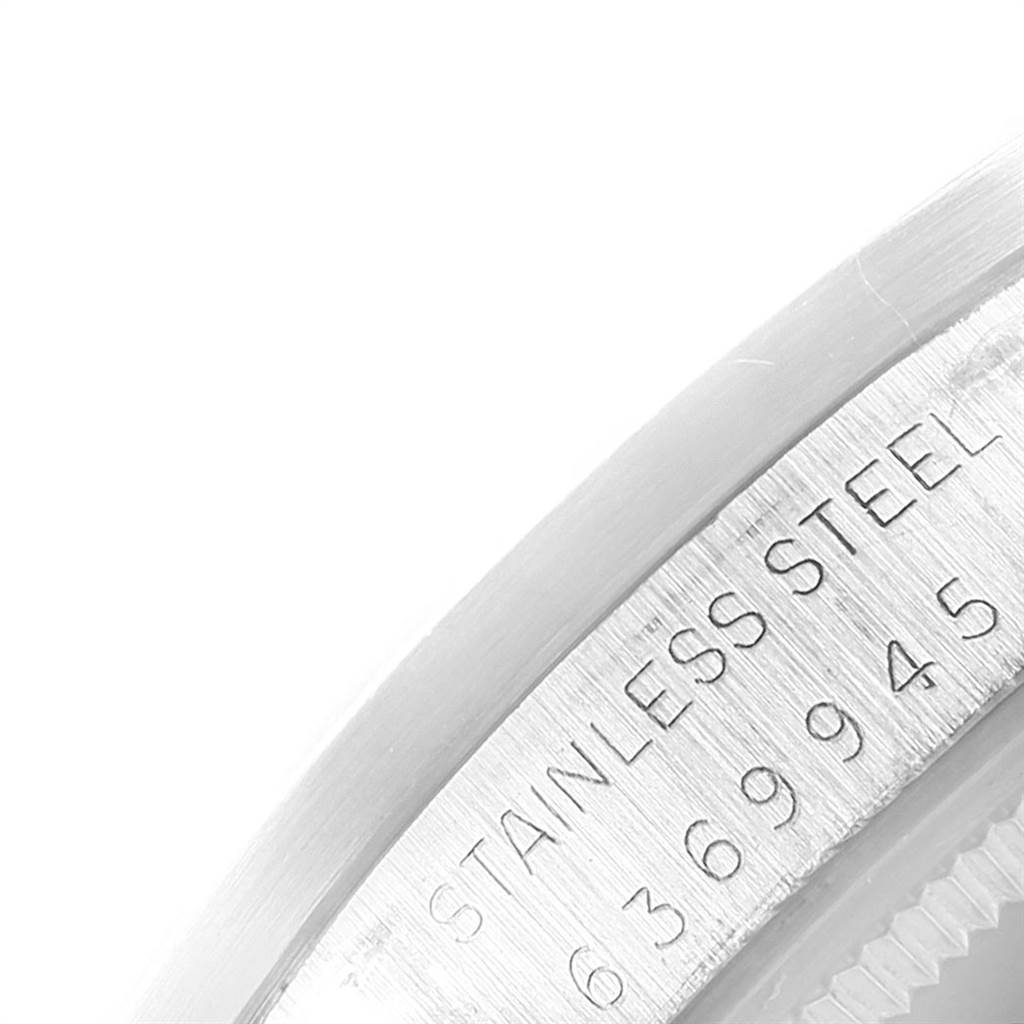 This image shows a close-up of the engraved stainless steel bezel of a Rolex Vintage Collection 1501 Men's Stainless Steel Blue Dial 1501 Men's Stainless Steel Blue Dial watch.