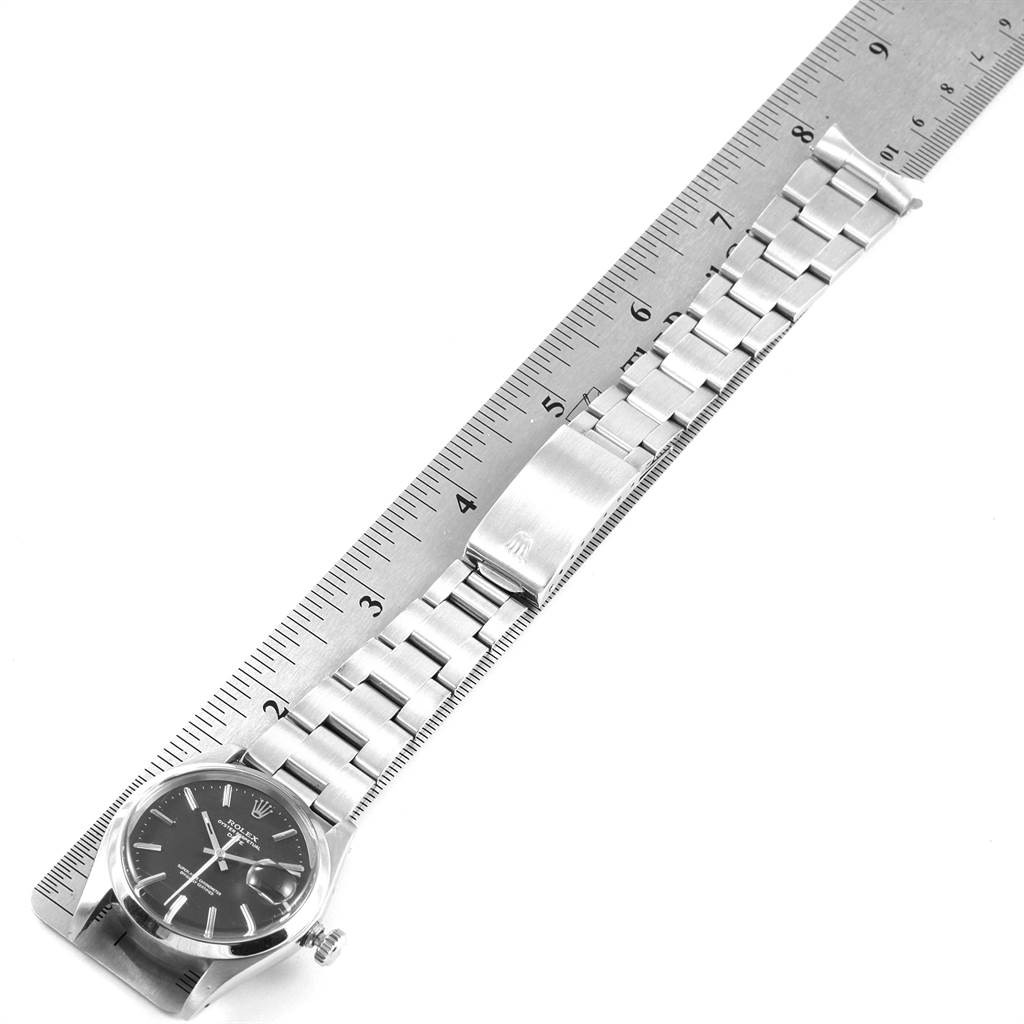 The image shows an overhead view of the Vintage Collection model by Rolex, displaying the watch face, bracelet, and clasp laid beside a ruler.