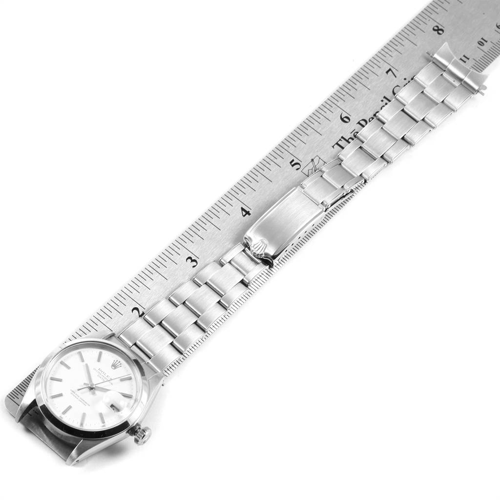 The image shows the Rolex Vintage Collection 1500 Men's Stainless Steel White Dial 1500 Men's Stainless Steel White Dial watch fully extended with its bracelet measured against a ruler.