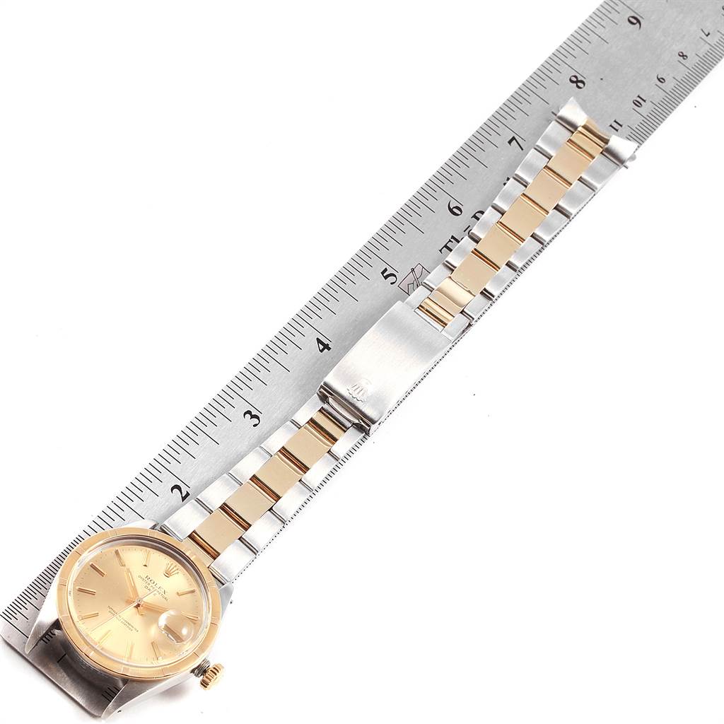 The image showcases a Rolex Vintage Collection 1500 Men's Steel and Gold (two tone) Champagne Dial 1500 Men's Steel and Gold (two tone) Champagne Dial watch, including its face, band, and clasp, measured alongside a ruler.