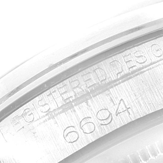 This close-up angle shows the engraved model number "6694" on the case edge of the Rolex Vintage Collection 6694 Men's Stainless Steel Black Dial 6694 Men's Stainless Steel Black Dial watch.