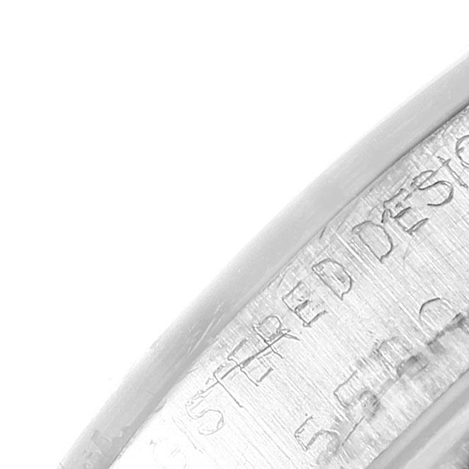 This image shows an angled close-up of the engraved edge of a Rolex Vintage Collection 5500 Men's Stainless Steel Silver Dial 5500 Men's Stainless Steel Silver Dial watch case.