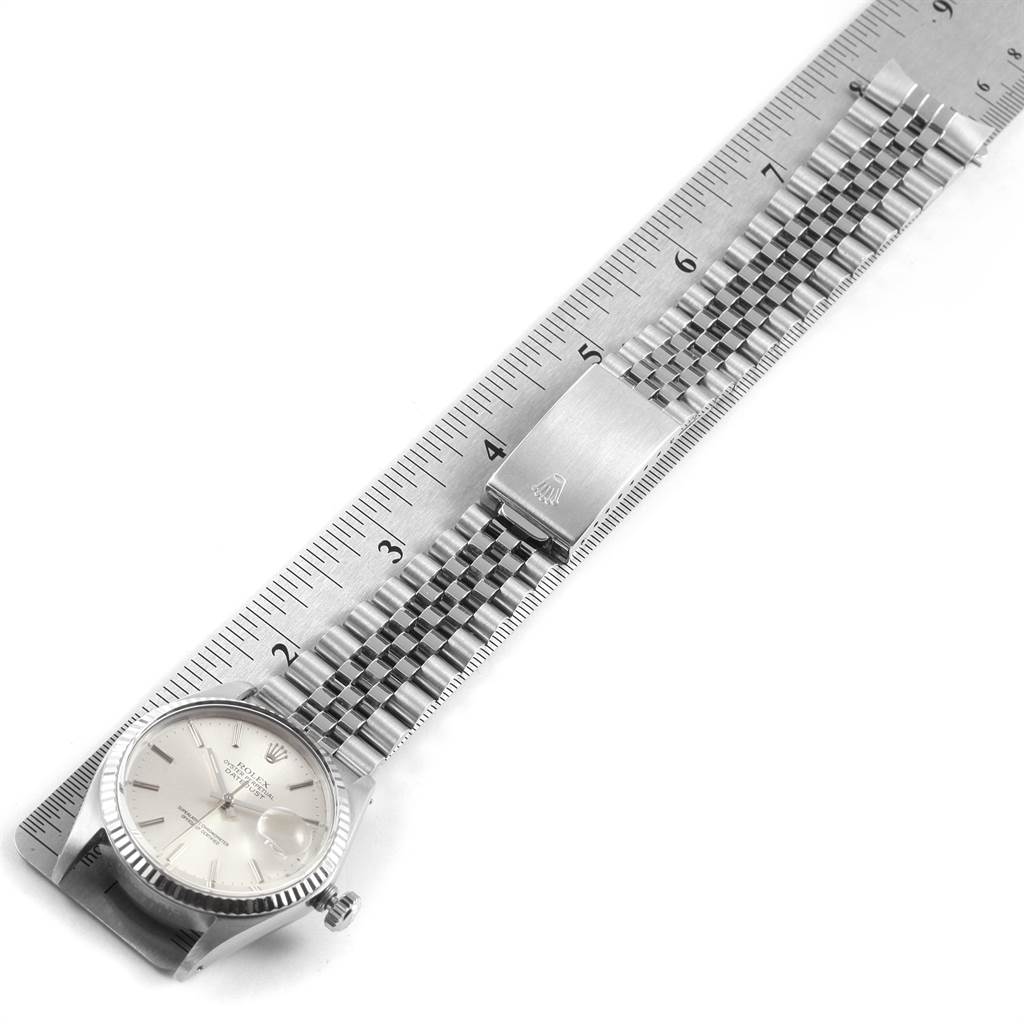The image shows the Rolex Vintage Collection 16014 Men's Stainless Steel Silver Dial 16014 Men's Stainless Steel Silver Dial watch laid flat alongside a ruler, displaying the face, bracelet, and clasp.