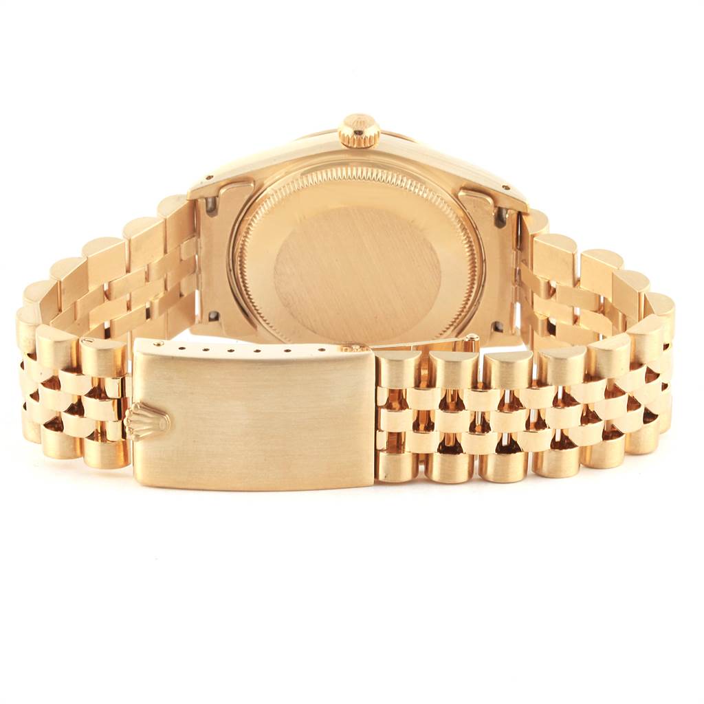 The image shows the back view of a Vintage Collection Rolex watch, highlighting its gold bracelet and clasp.