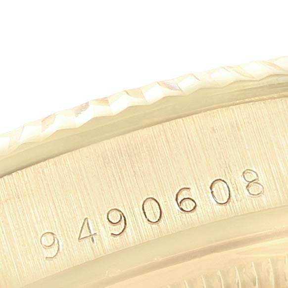 The image shows a close-up of the serial number and fluted bezel on the Rolex Vintage Collection 15037 Men's Yellow Gold Champagne Dial 15037 Men's Yellow Gold Champagne Dial model.