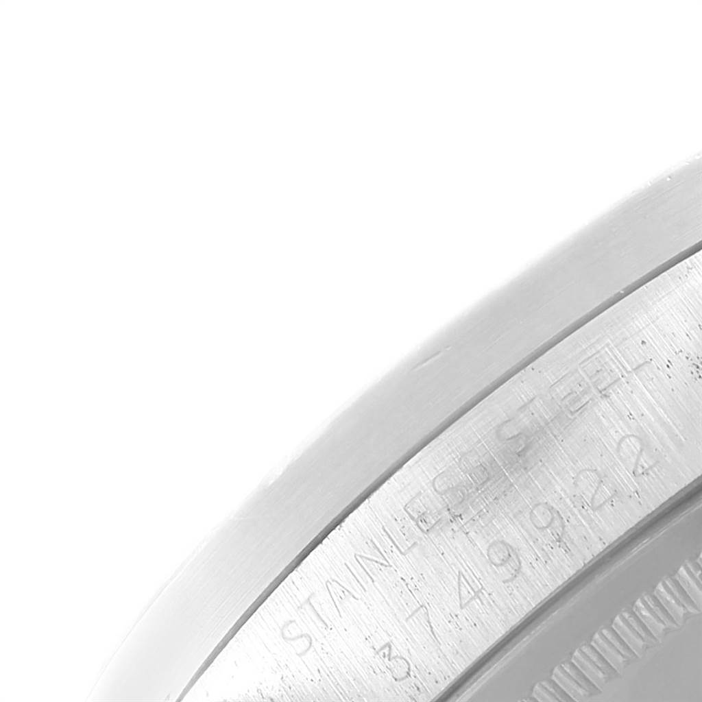 The image shows a close-up of the edge of a Rolex Vintage Collection 1501 Men's Stainless Steel Silver Dial 1501 Men's Stainless Steel Silver Dial watch case, featuring its engraved stainless steel details.