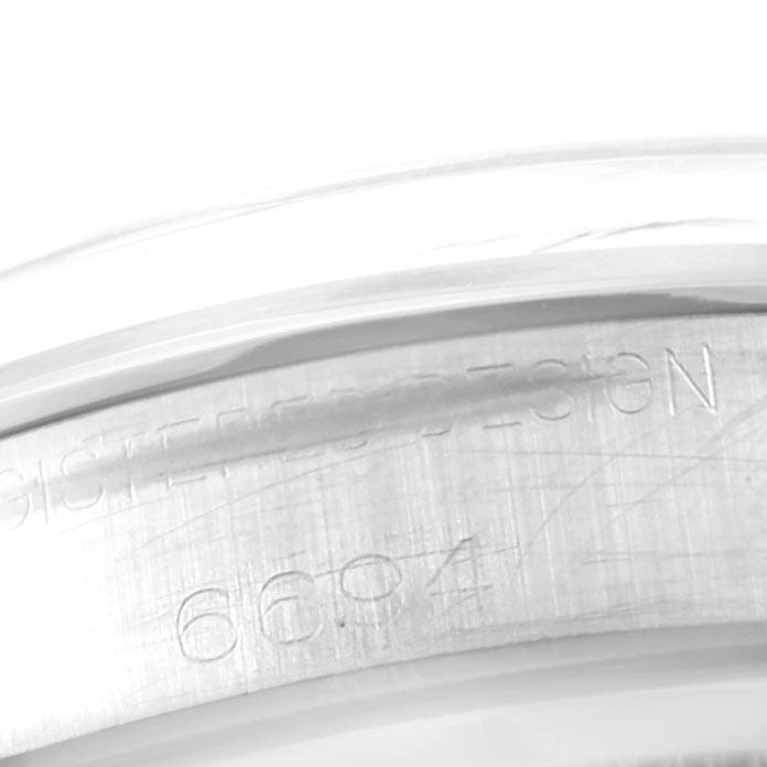 The image shows a close-up of the engraved serial number on the back case of the Rolex Vintage Collection 6694 Men's Stainless Steel Champagne Dial 6694 Men's Stainless Steel Champagne Dial model watch.