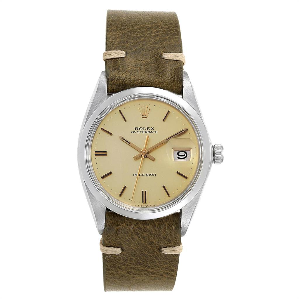The image shows a frontal view of a Rolex Vintage Collection 6694 Men's Stainless Steel Champagne Dial 6694 Men's Stainless Steel Champagne Dial watch with a tan face and a brown leather strap.