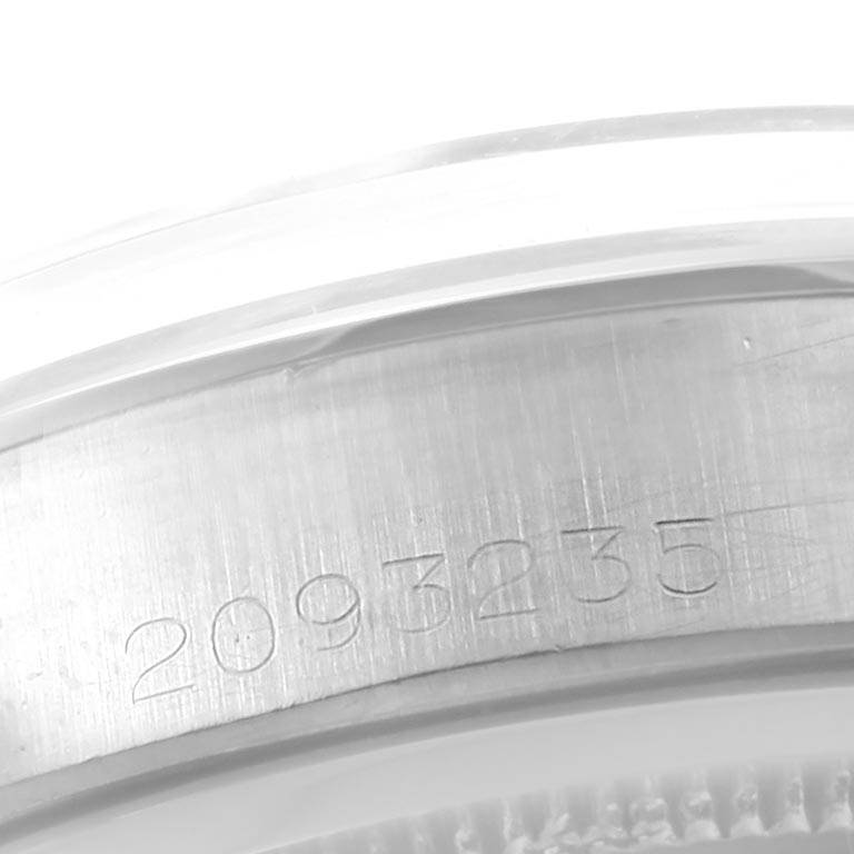 The image shows a close-up of the serial number engraving on the bezel of a Rolex Vintage Collection 6694 Men's Stainless Steel Champagne Dial 6694 Men's Stainless Steel Champagne Dial model.