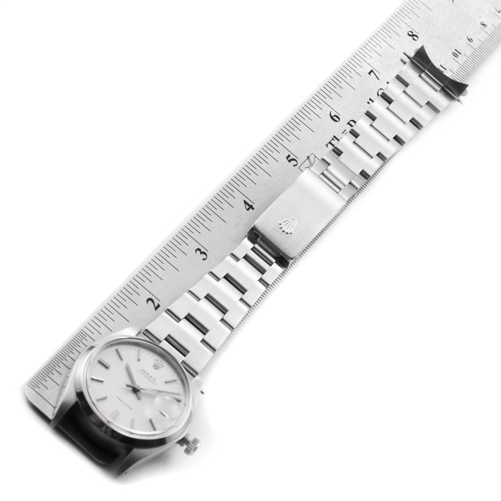 The image shows a Rolex Vintage Collection 6694 Men's Stainless Steel Silver Dial 6694 Men's Stainless Steel Silver Dial watch horizontally aligned with a ruler, displaying the face and metal bracelet.