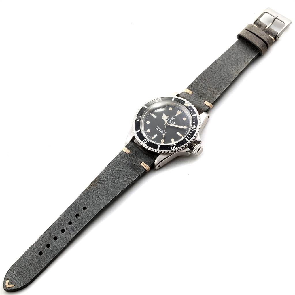 The Rolex Vintage Collection 5513 Men's Stainless Steel Black Dial 5513 Men's Stainless Steel Black Dial model watch is shown at an angled top-down view, displaying the face, bezel, crown, and leather strap.