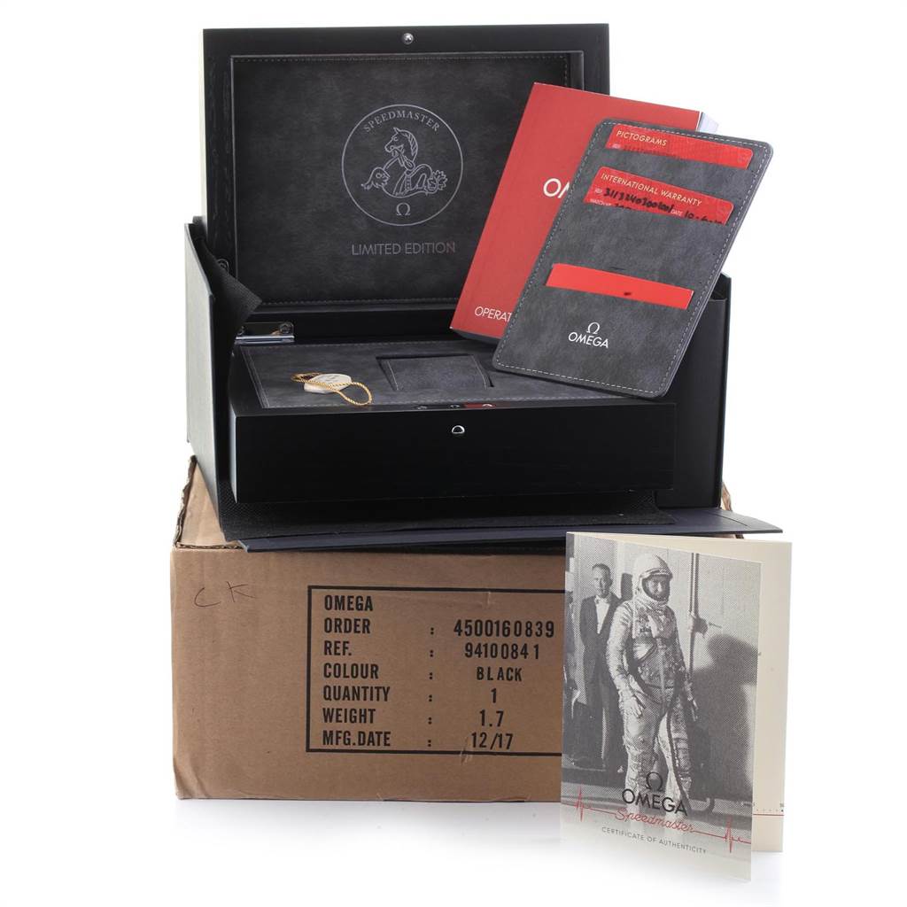 The image shows an Omega Speedmaster 311.32.40.30.02.001 Men's Stainless Steel Silver Dial 311.32.40.30.02.001 Men's Stainless Steel Silver Dial watch box, instruction manuals, a certificate of authenticity, and a warranty card.
