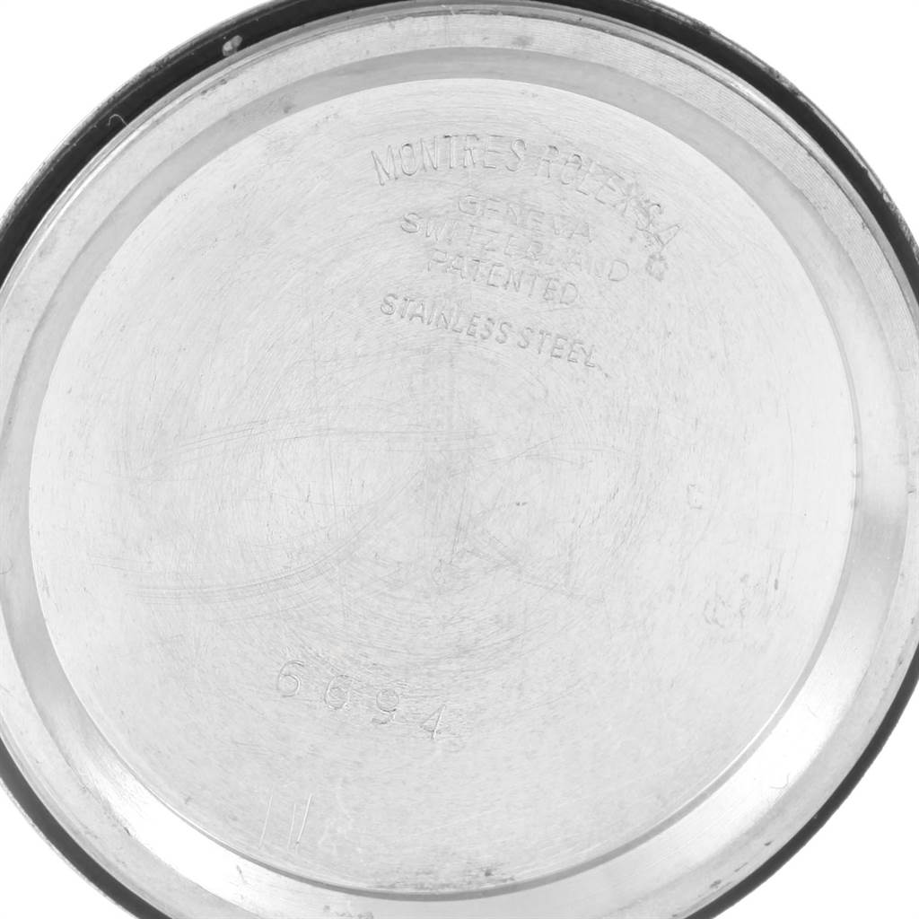 This image shows the interior back cover of a Rolex Vintage Collection 6694 Men's Stainless Steel Black Dial 6694 Men's Stainless Steel Black Dial watch, displaying engravings and the model number.