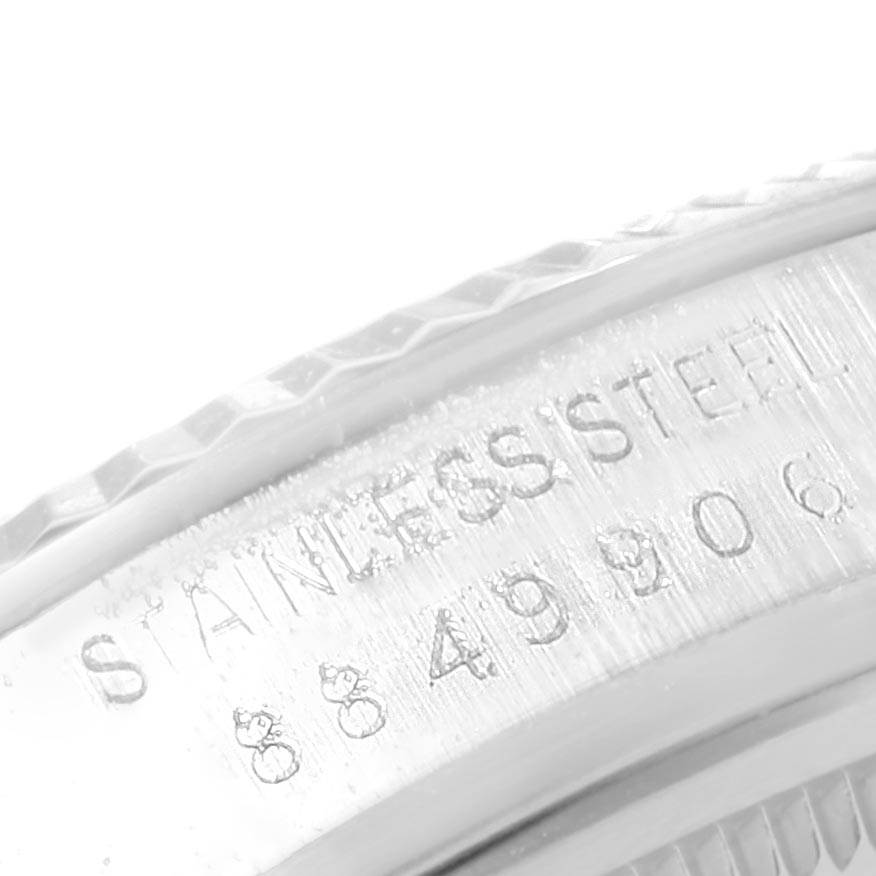 This is a close-up side view of the stainless steel casing of a Rolex Vintage Collection 16014 Men's Stainless Steel Silver Dial 16014 Men's Stainless Steel Silver Dial model watch showing its engraving.
