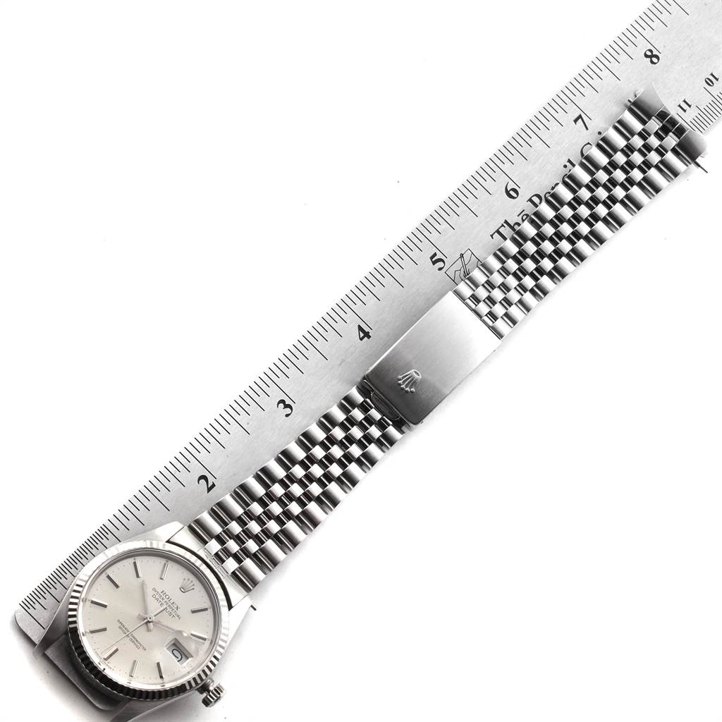 The Vintage Collection Rolex watch is shown flat with the face, bracelet, and clasp visible, next to a ruler for scale.
