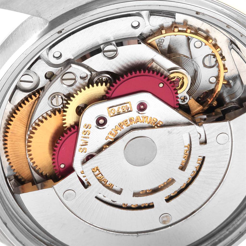 The image shows a close-up view of the internal mechanism of the Rolex Vintage Collection 1601 Men's Stainless Steel Silver Dial 1601 Men's Stainless Steel Silver Dial watch, highlighting the gears and movement components.