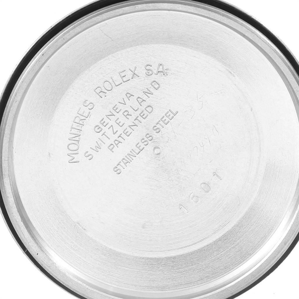 This image shows the inner case back of a Rolex Vintage Collection 1601 Men's Stainless Steel Silver Dial 1601 Men's Stainless Steel Silver Dial model, highlighting inscriptions and markings.