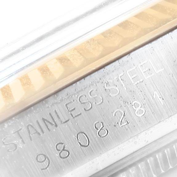 The image shows a close-up of the side of a Rolex Vintage Collection 16013 Men's Stainless Steel Champagne Dial 16013 Men's Stainless Steel Champagne Dial model watch, highlighting the stainless steel case and engraved serial number.